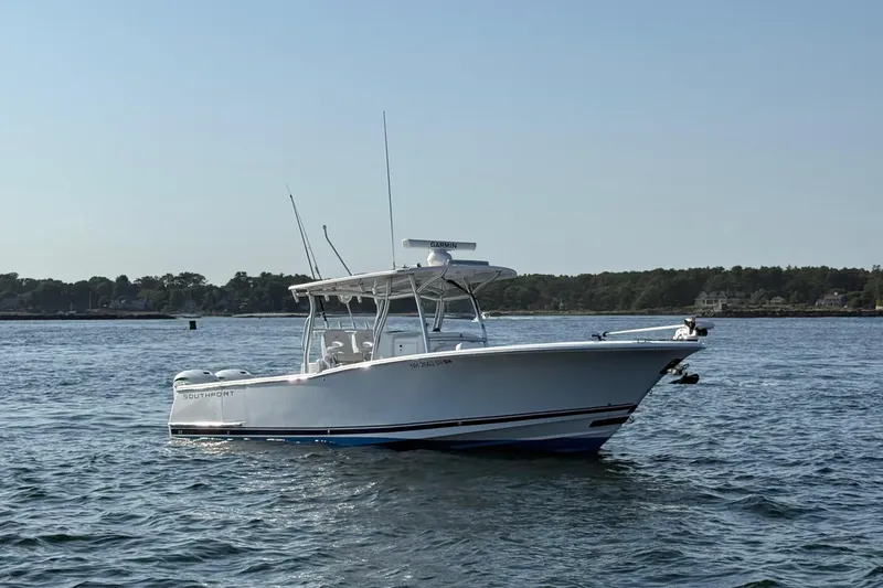 Slide: The Image of 2020 Southport 33 FE boat on calm water, clear sky background. - 5