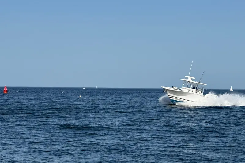Slide: The Image of 2020 Southport 33 FE boat cruising on open sea under clear blue sky. - 11