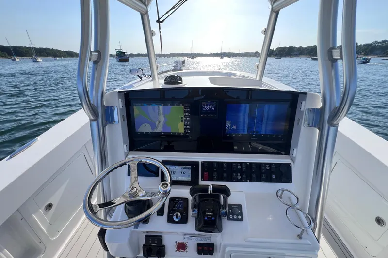 Slide: The Image of 2020 Southport 33 FE boat helm with navigation screens on a sunny day. - 26