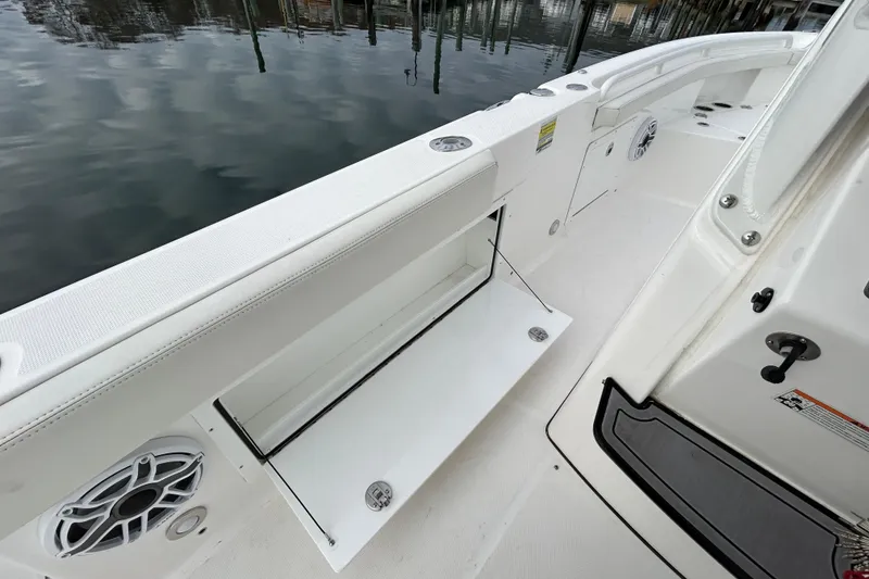 Slide: The Image of 2023 Everglades 235 Center Console boat interior with open storage compartment. - 23
