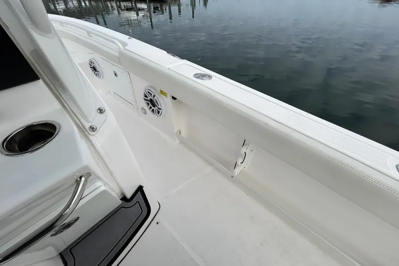 Slide: The Image of 2023 Everglades 235 Center Console boat interior with speakers and cup holder. - 24