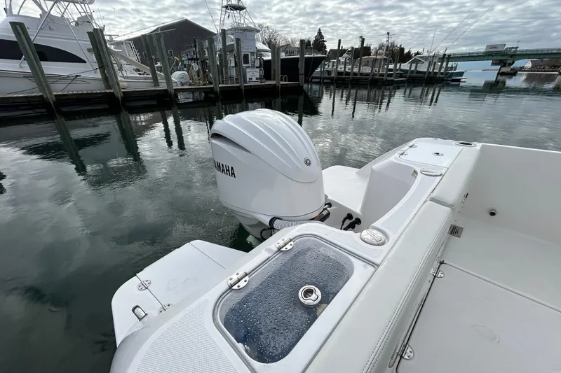 Slide: The Image of 2023 Everglades 235 Center Console boat with Yamaha engine docked at marina. - 19
