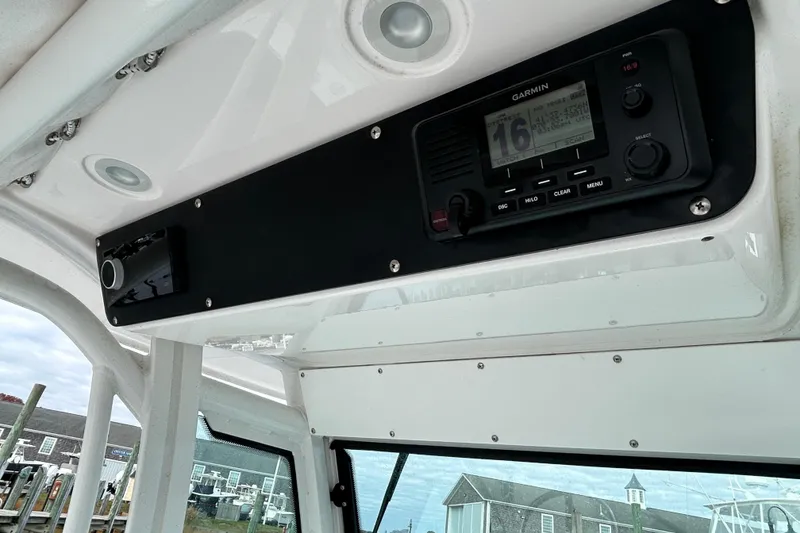 Slide: The Image of 2023 Everglades 235 Center Console boat dashboard with Garmin marine radio. - 14