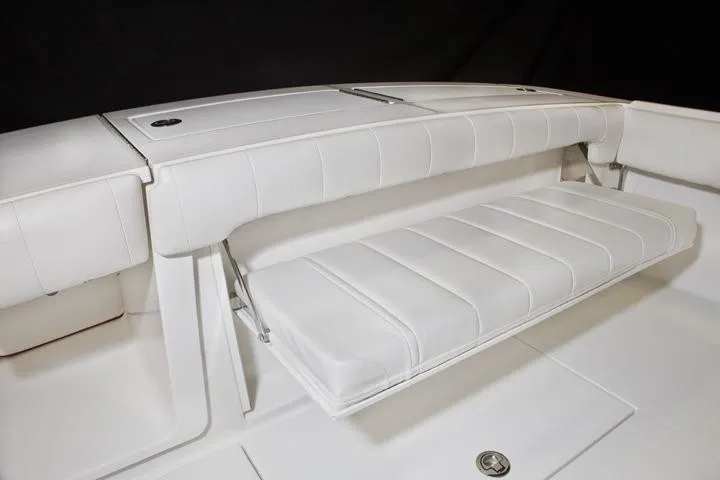 Slide: The Image of 2016 Regulator 28 Forward Seating, white bench seat in boat. - 19