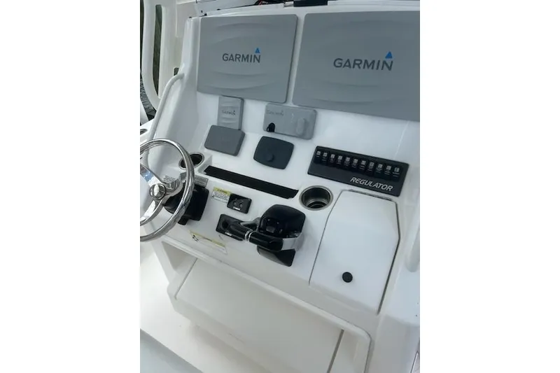 Slide: The Image of Control panel of a 2016 Regulator 28 Forward Seating boat with Garmin displays. - 13