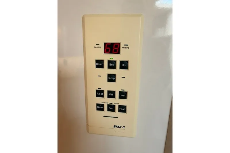 Slide: The Image of Control panel of a 1997 Sea Ray Sundancer 400, displaying temperature settings. - 28