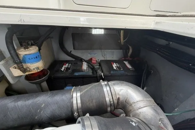 Slide: The Image of Engine compartment of a 1997 Sea Ray Sundancer 400 with visible batteries and wiring. - 42