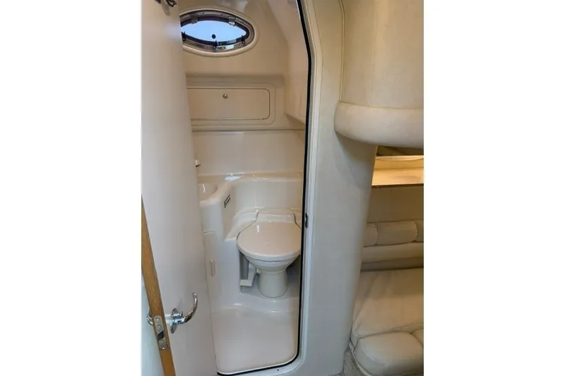 Slide: The Image of 1997 Sea Ray Sundancer 400 yacht bathroom interior with compact design and porthole window. - 29