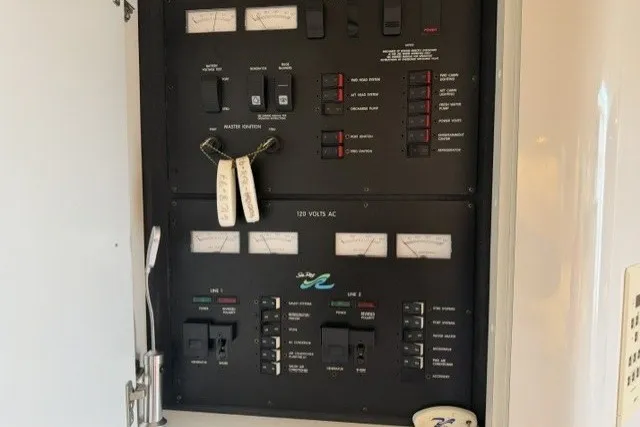 Slide: The Image of Electrical panel of a 1997 Sea Ray Sundancer 400 boat, featuring various switches and gauges. - 36