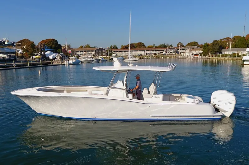Slide: The Image of 2023 Mag Bay 33 CC boat on calm water, side view. - 9