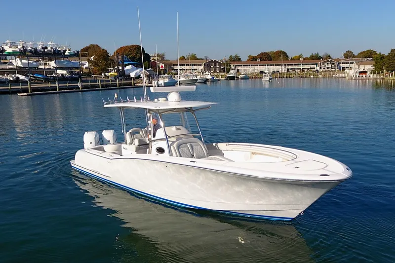 Slide: The Image of 2023 Mag Bay 33 CC boat on calm water, clear sky background. - 39