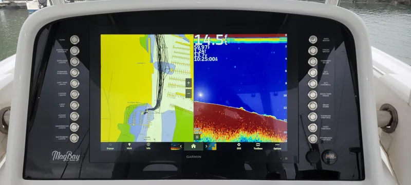 Slide: The Image of Mag Bay 33 CC 2023 boat navigation display with sonar and map interface. - 23