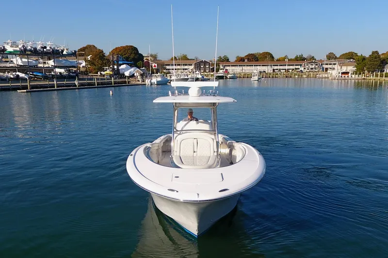 Slide: The Image of 2023 Mag Bay 33 CC boat on calm water near marina. - 11
