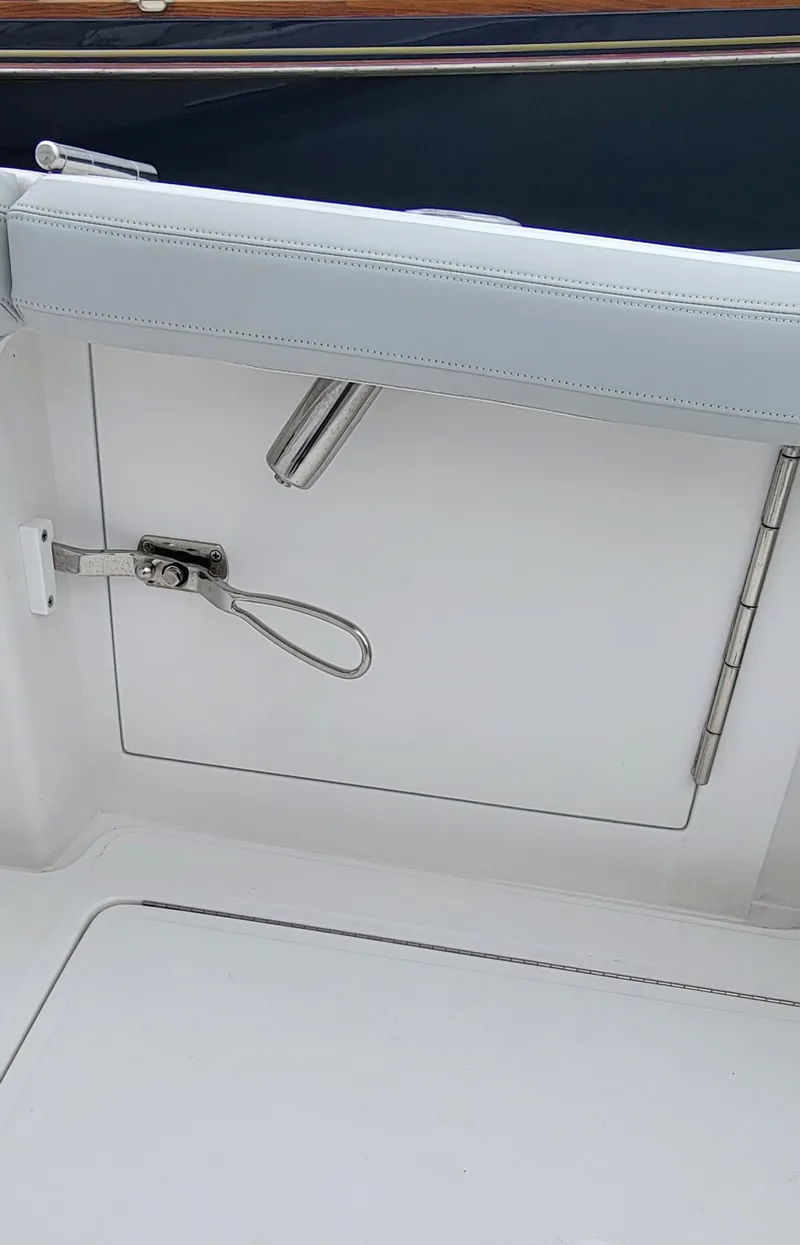 Slide: The Image of 2023 Mag Bay 33 CC boat interior detail with white upholstery and stainless steel hardware. - 32