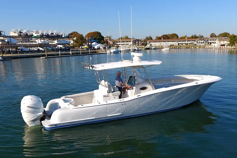 Slide: The Image of 2023 Mag Bay 33 CC boat on calm water, side view. - 6