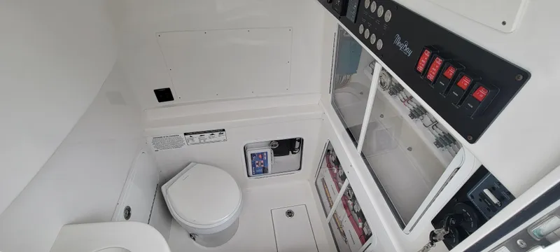Slide: The Image of Interior of 2023 Mag Bay 33 CC boat with toilet and control panel. - 36