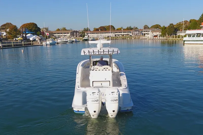 Slide: The Image of 2023 Mag Bay 33 CC boat with dual engines on calm water. - 7