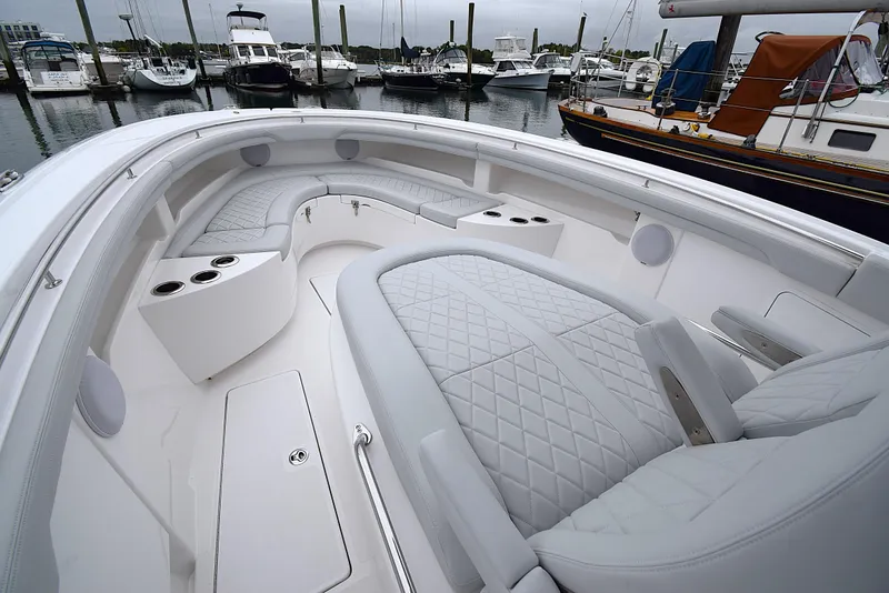 Slide: The Image of Luxurious 2023 Mag Bay 33 CC boat interior with quilted seating at marina. - 16
