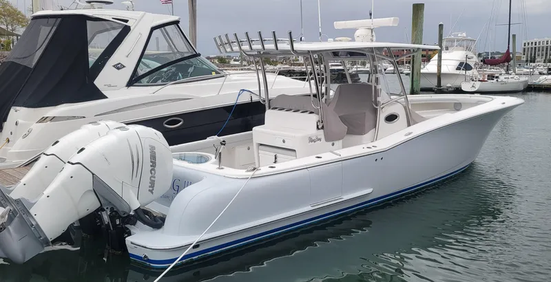 Slide: The Image of 2023 Mag Bay 33 CC boat docked in marina, featuring sleek design and powerful engines. - 15