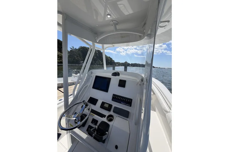 Slide: The Image of 2015 Regulator 25 boat console with steering wheel and navigation equipment. - 16