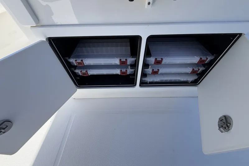 Slide: The Image of Storage compartments with tackle boxes on a 2015 Regulator 25 boat. - 35