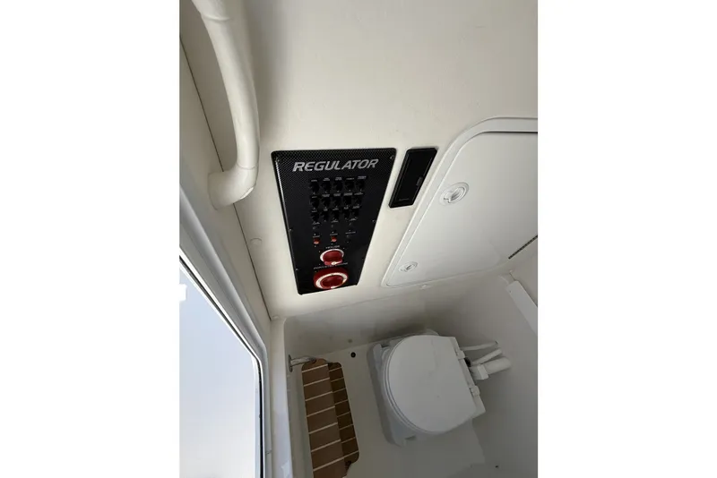 Slide: The Image of 2015 Regulator 25 boat interior with control panel and marine toilet. - 41