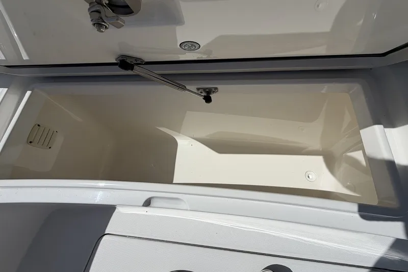 Slide: The Image of Open storage compartment on a 2015 Regulator 25 boat, showcasing interior space. - 21