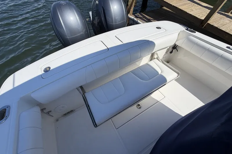 Slide: The Image of 2015 Regulator 25 boat interior with cushioned seating and dual outboard motors. - 38