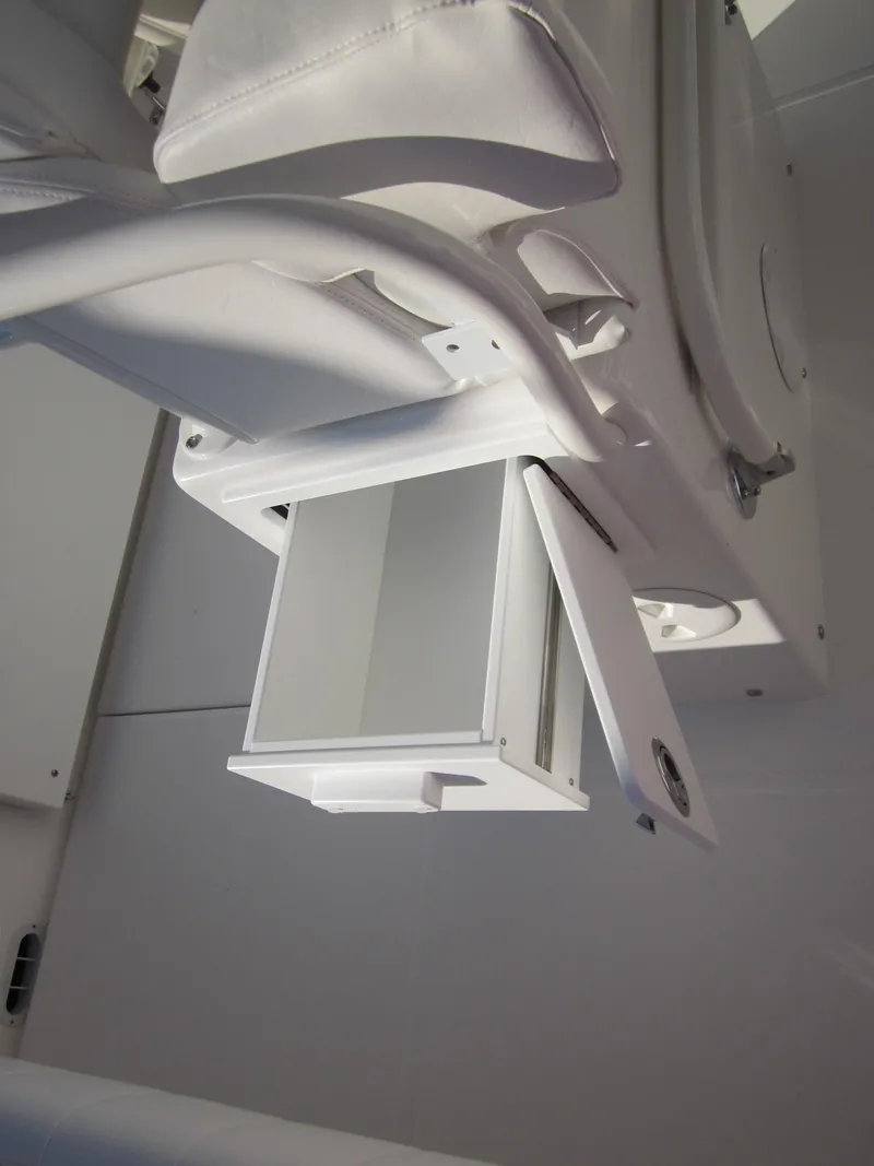 Slide: The Image of A white storage compartment with a fold-down door on a boat. - 34