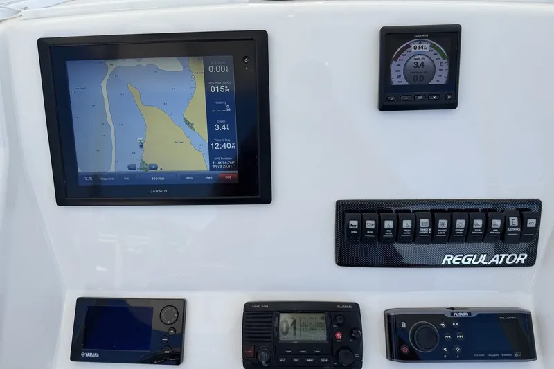 Slide: The Image of Control panel of a 2015 Regulator 25 boat with navigation and communication systems. - 14