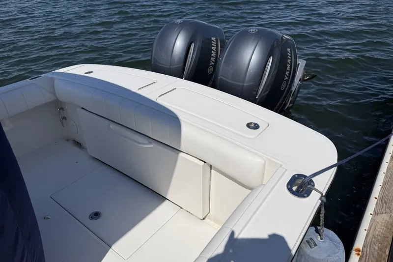 Slide: The Image of 2015 Regulator 25 boat with twin Yamaha engines docked on water. - 37