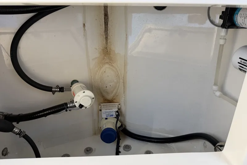 Slide: The Image of 2015 Regulator 25 boat interior showing plumbing and wiring components. - 40
