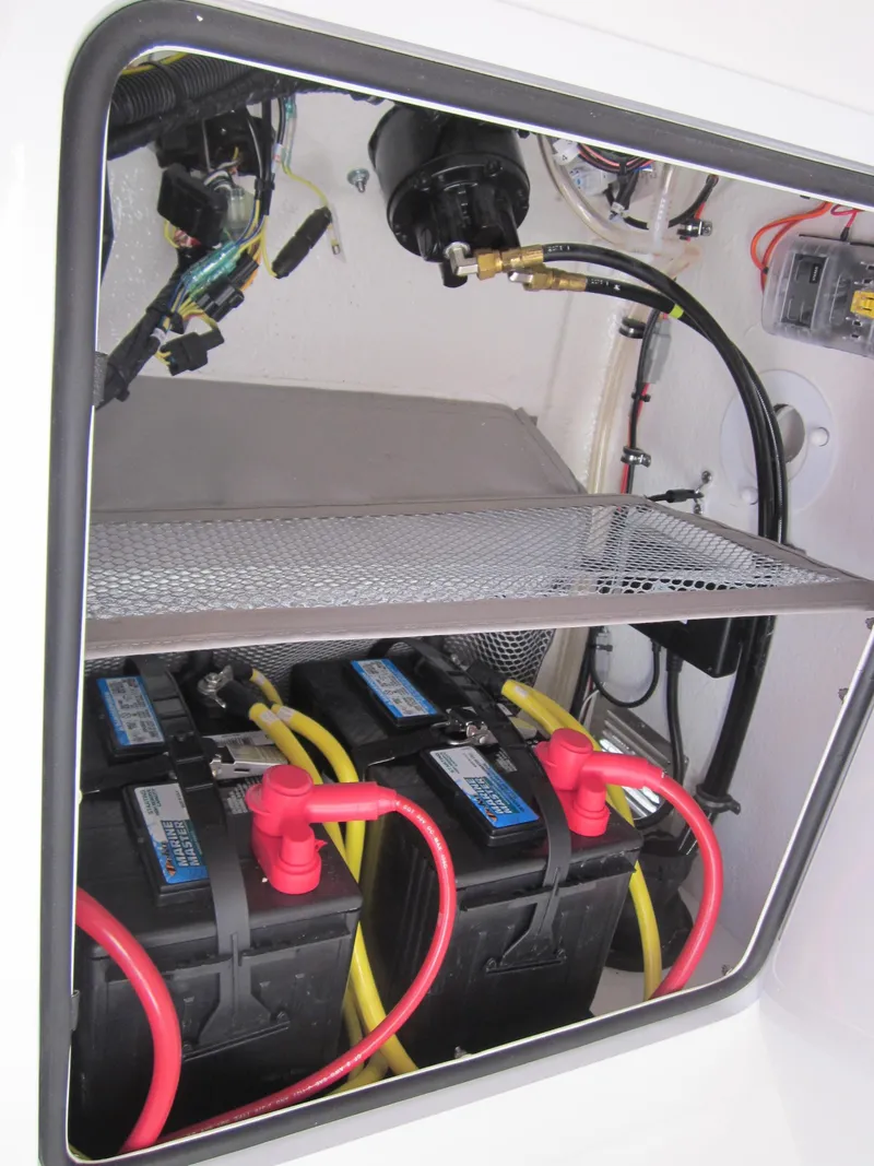 Slide: The Image of Battery compartment of a Regulator 25 boat with two batteries and wiring. - 43