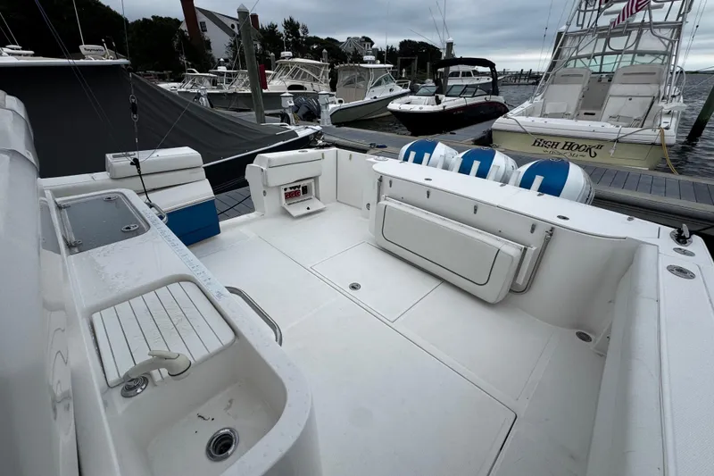 Slide: The Image of 2017 Stamas 390 Tarpon boat interior at dock, featuring spacious seating and fishing amenities. - 13