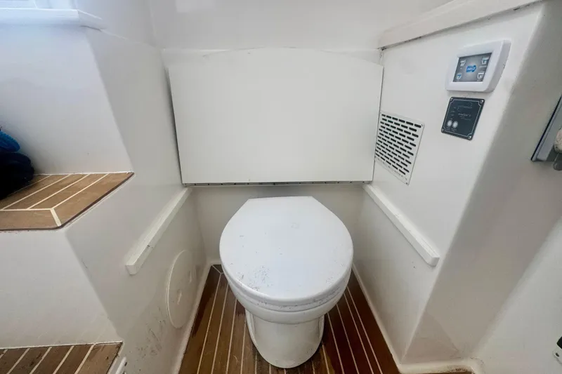 Slide: The Image of 2017 Stamas 390 Tarpon boat interior with a compact marine toilet setup. - 5