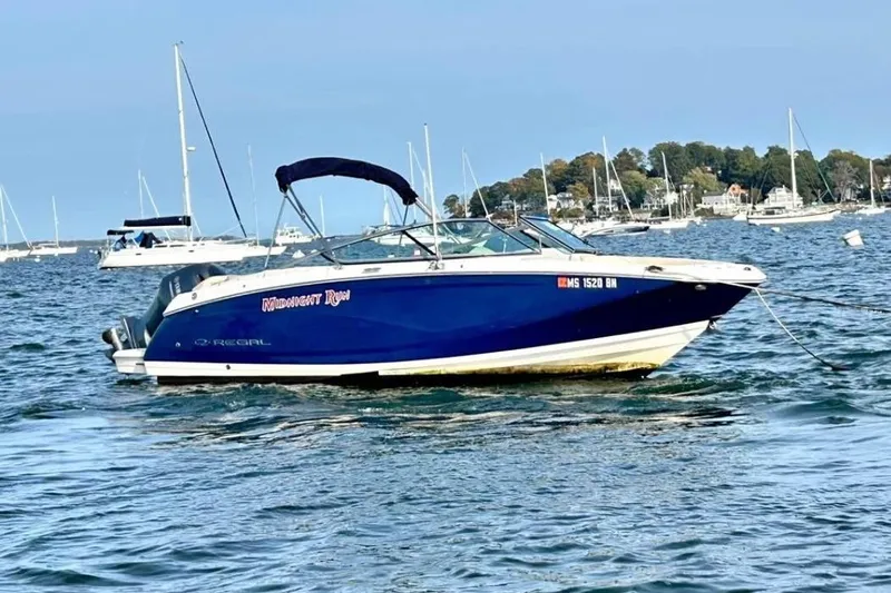 The Image of 2020 Regal 23 OBX boat anchored on water with scenic background. - 1