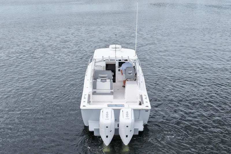 Slide: The Image of 2024 Albemarle 30 Express boat on water, rear view with dual engines. - 13
