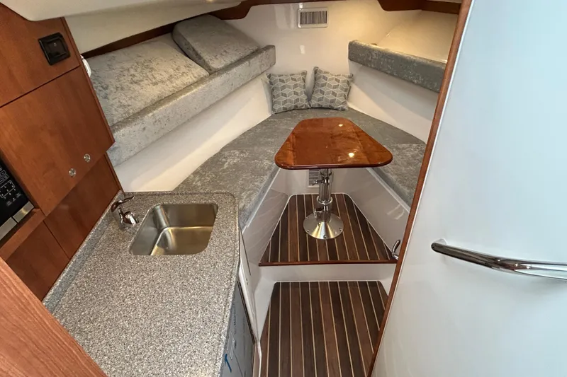 Slide: The Image of 2024 Albemarle 30 Express cabin interior with kitchenette, sink, and cozy seating area. - 60