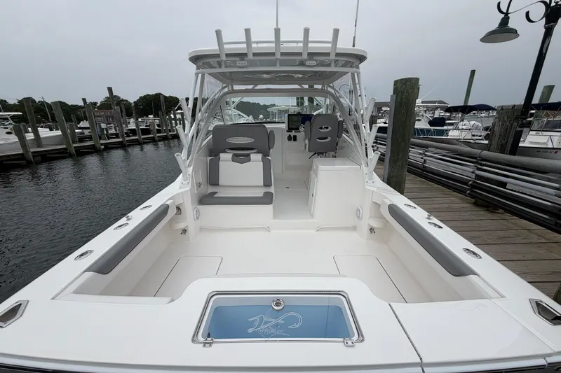 Slide: The Image of 2024 Albemarle 30 Express boat docked, showcasing spacious deck and seating area. - 24