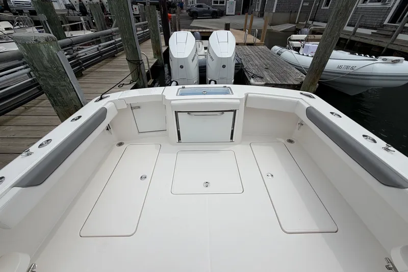 Slide: The Image of 2024 Albemarle 30 Express boat deck with twin engines at dock. - 17