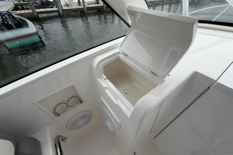 Slide: The Image of 2024 Albemarle 30 Express boat interior with open storage compartment and cup holders. - 55