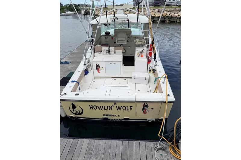 Slide: The Image of 2003 Rampage 38 Express boat named "Howlin' Wolf" docked at a marina. - 2