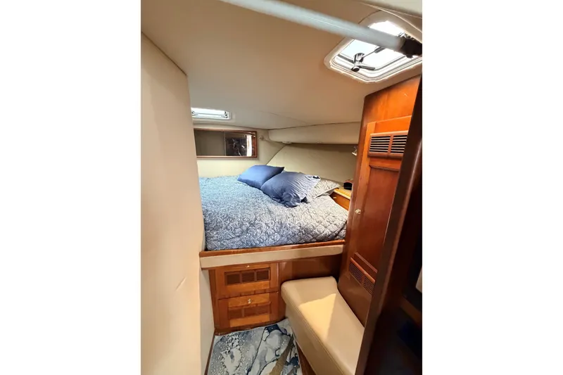 Slide: The Image of Cozy cabin interior of 2003 Rampage 38 Express with bed and wooden cabinetry. - 7