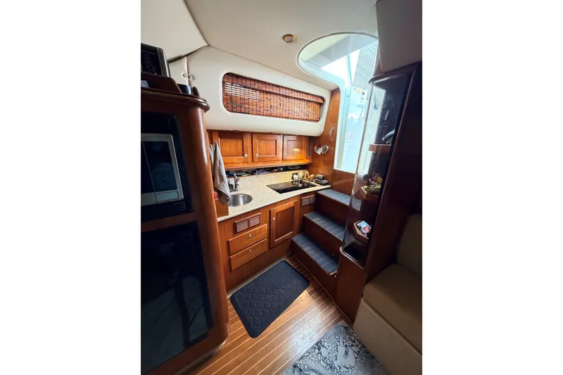 Slide: The Image of Luxurious 2003 Rampage 38 Express yacht interior with wooden cabinetry and modern amenities. - 8