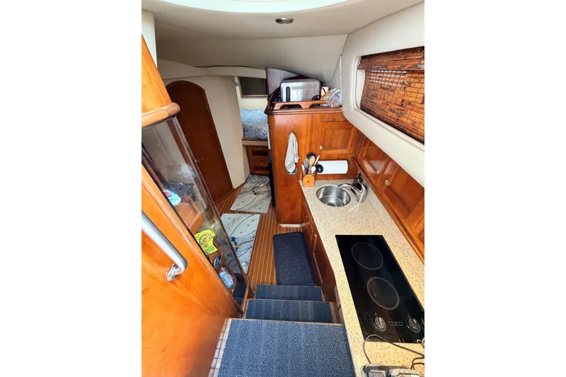 Slide: The Image of Interior of 2003 Rampage 38 Express yacht with kitchenette and wooden cabinetry. - 5