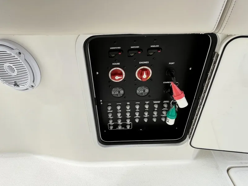 Slide: The Image of Control panel of a 2018 Boston Whaler 330 Outrage boat with switches and speaker. - 28