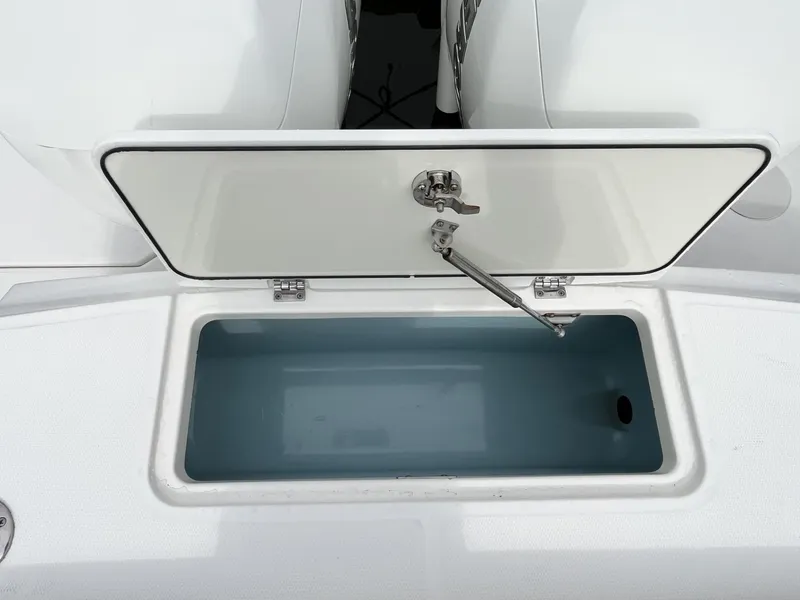 Slide: The Image of Open storage compartment on a 2018 Boston Whaler 330 Outrage boat. - 13