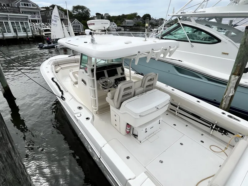Slide: The Image of 2018 Boston Whaler 330 Outrage docked, showcasing spacious deck and modern design. - 5
