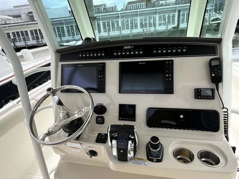Slide: The Image of Control panel of a 2018 Boston Whaler 330 Outrage boat with navigation screens. - 21