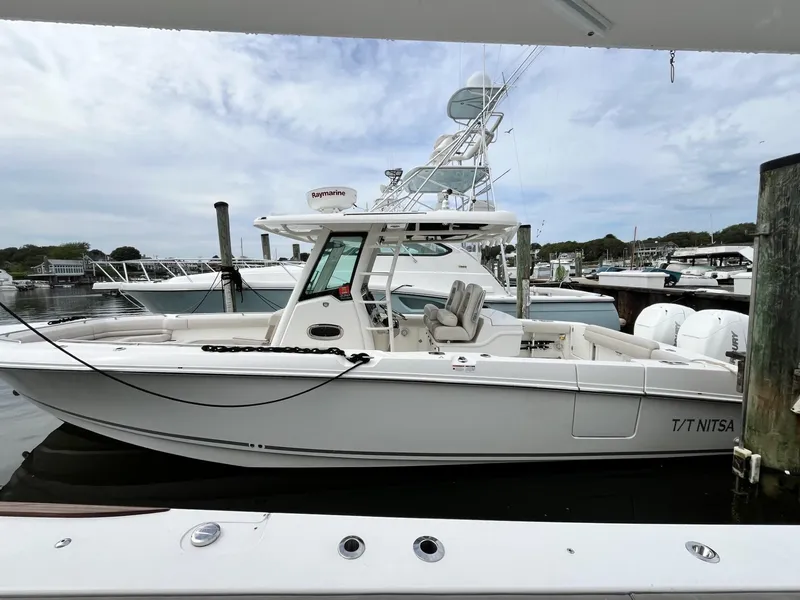 The Image of 2018 Boston Whaler 330 Outrage docked at marina, side view. - 1